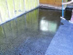 Applying the indensifier to a concrete floor