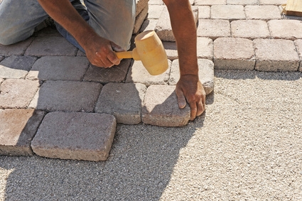 tap pavers into place